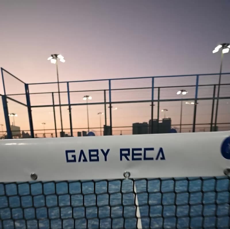 Outdoor courts at a padel academy in Dubai at dusk